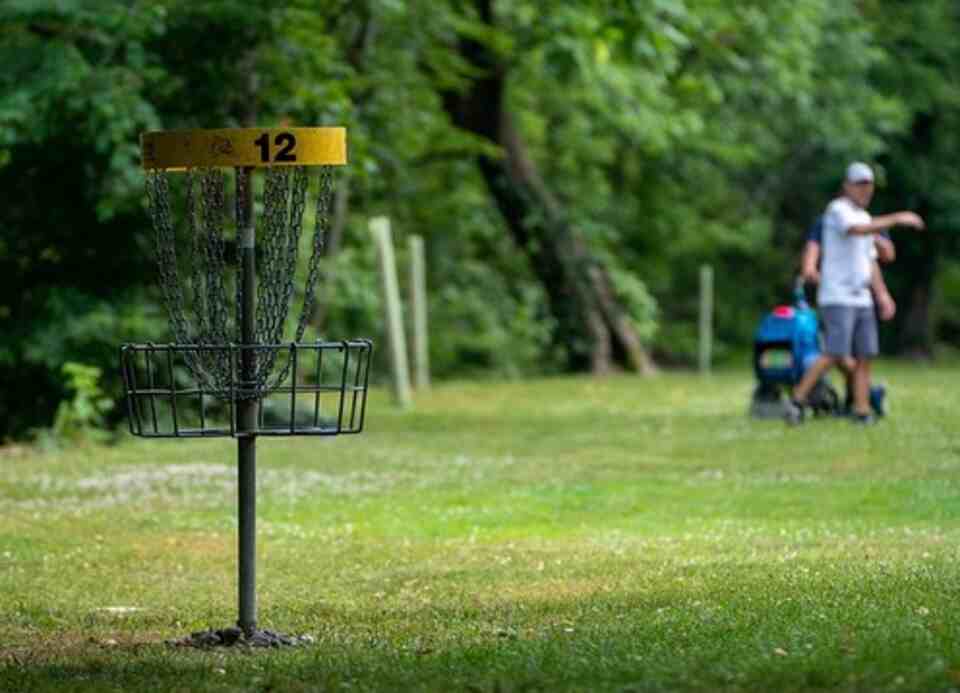 A person practicing disc golf shots.