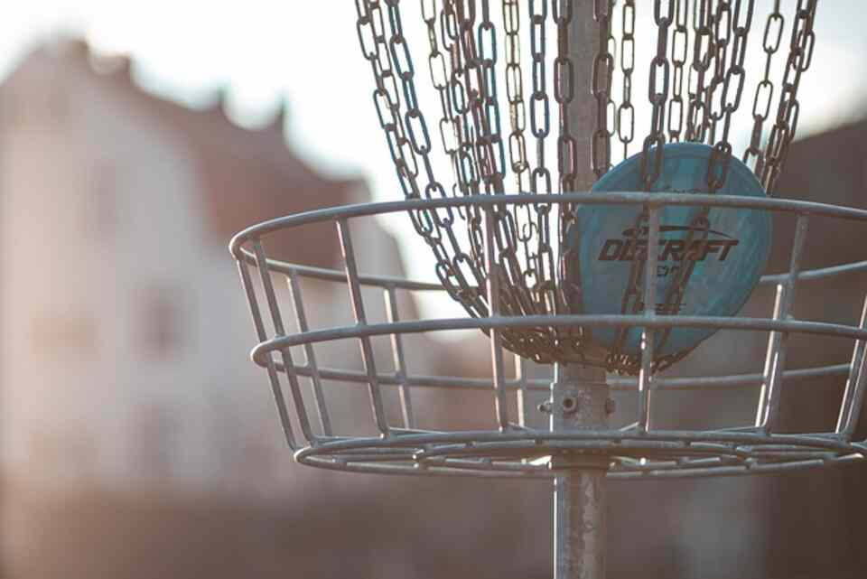 A disc golf disc in a basket.