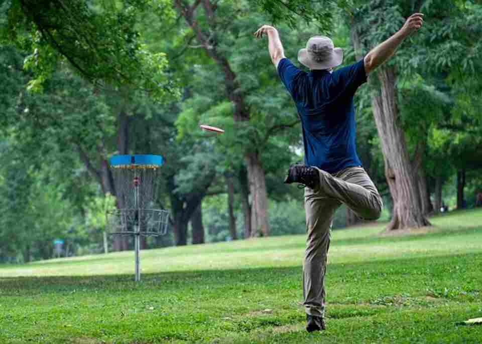 A man throwing a disc golf disc.
