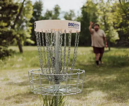A man in a park playing disc golf.