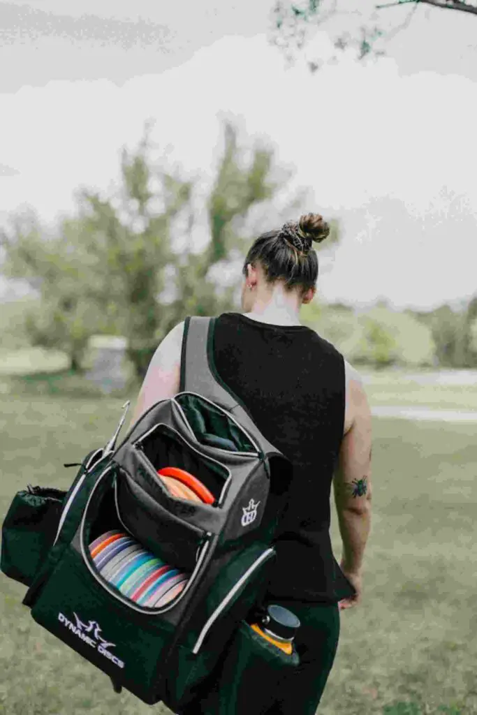 A woman with backpack of discs.